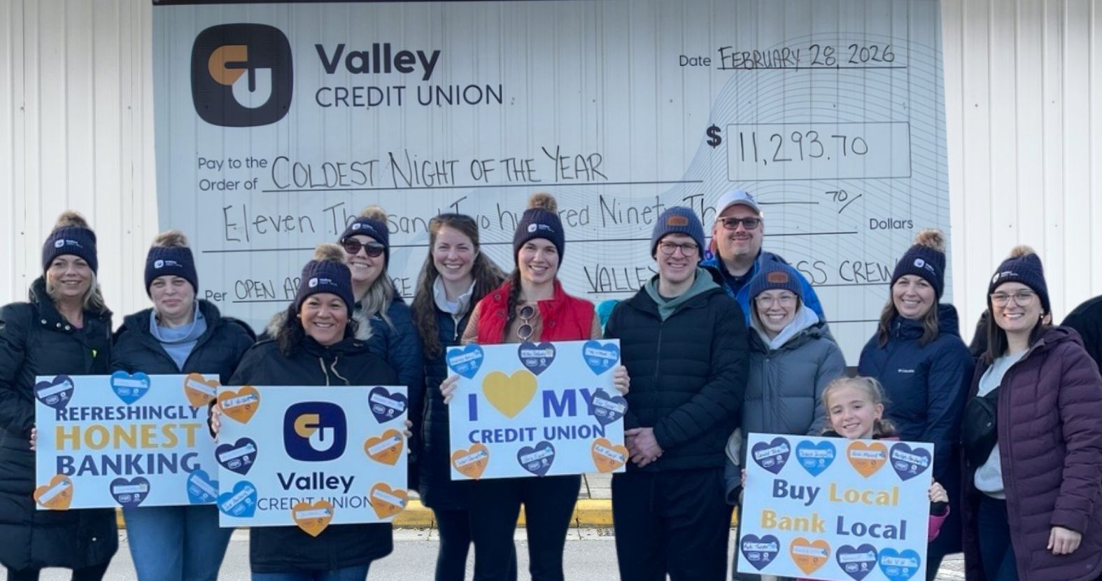 group of walkers holding a cheque and signs
